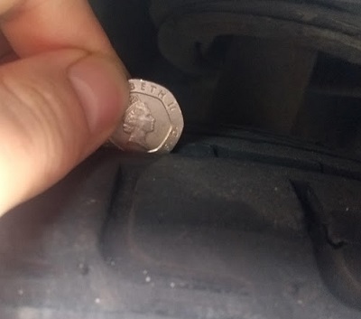 testing tyre tread depth with a 20p